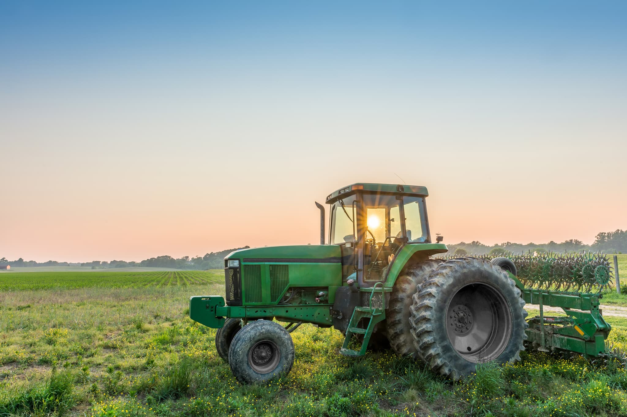 Green tractor cutting grass